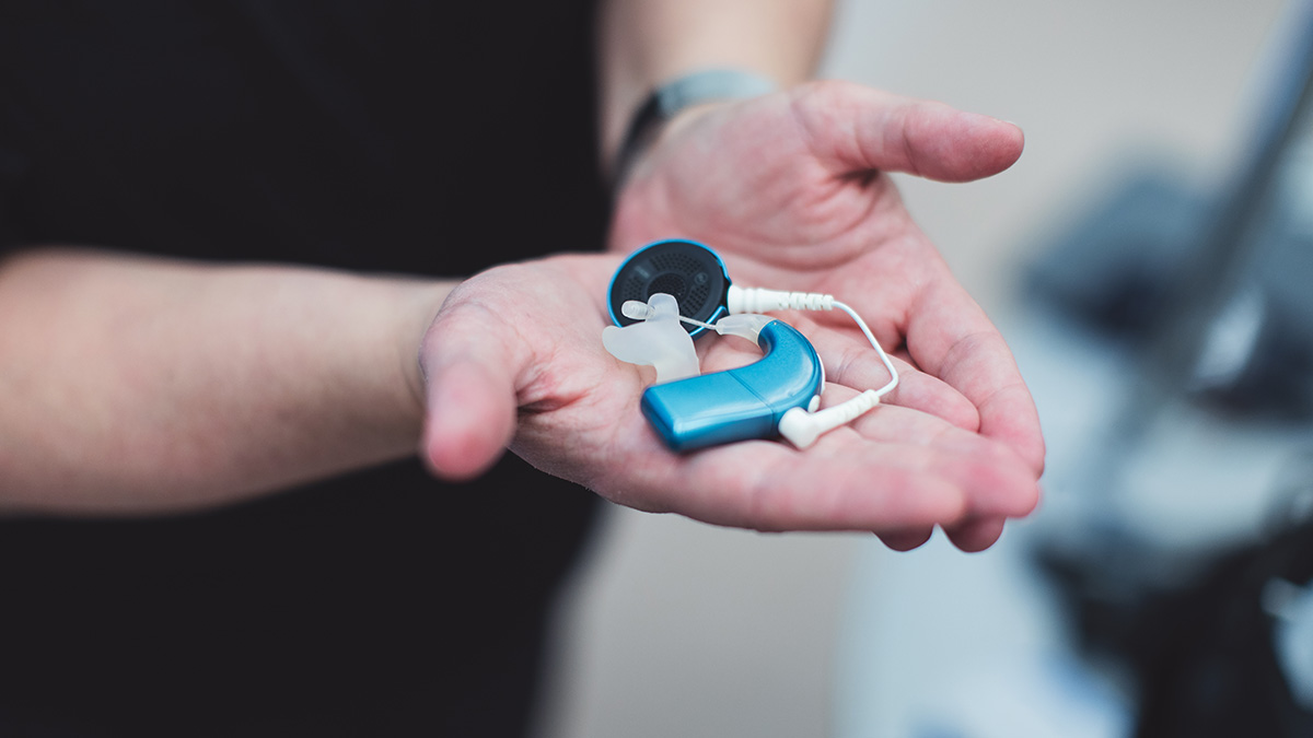 Kim’s Cochlear Implant processor, worn while teaching. Not pictured: battery and audio boot that was provided by the board to connect to the Rogers FM system. Kim wears a hearing aid on the other ear, which is not pictured, but also has an audio shoe and connects to the devices provided.