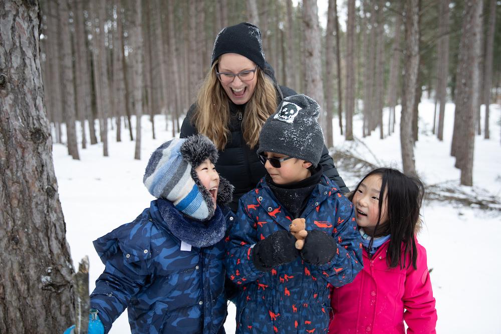 teacher with students outside in snow