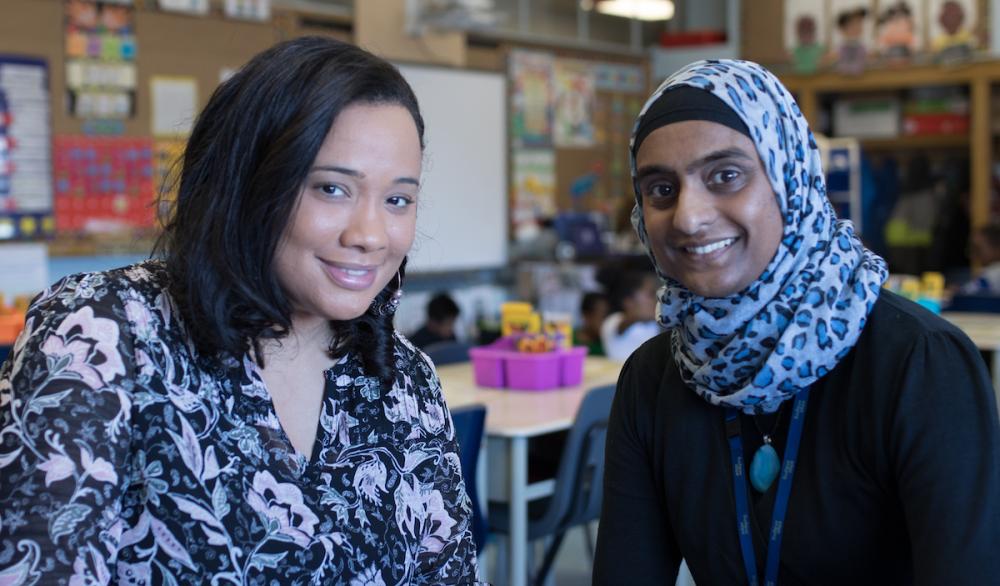 Two people sitting together in classroom