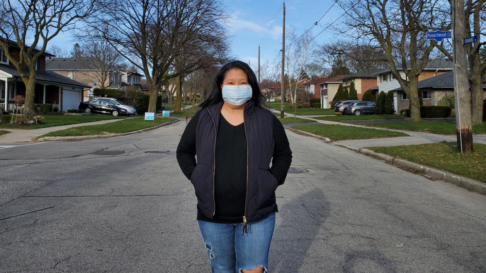 Woman standing in street wearing face mask