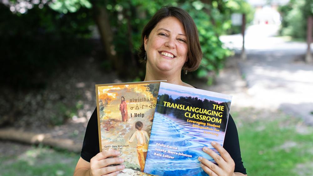 Katie Brabacher holding books outside