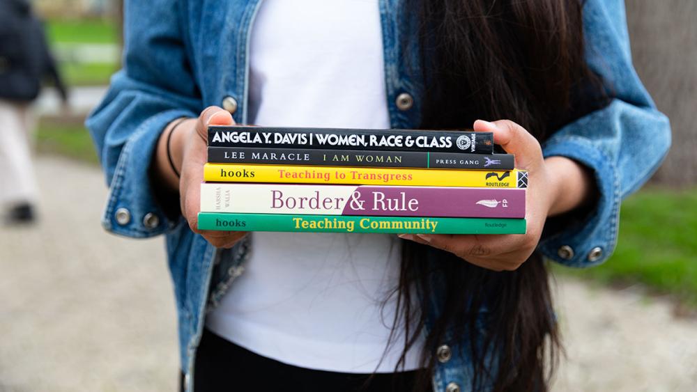 Neeru holding books related to feminism