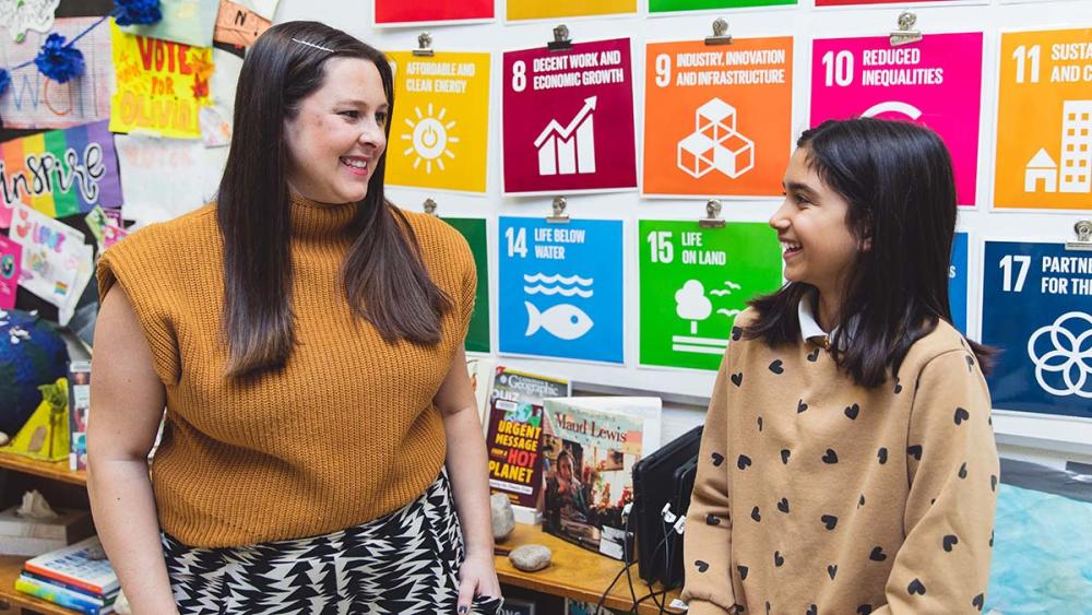 Sarah Lowes and Gweneth Arumainayaga talking in a classroom