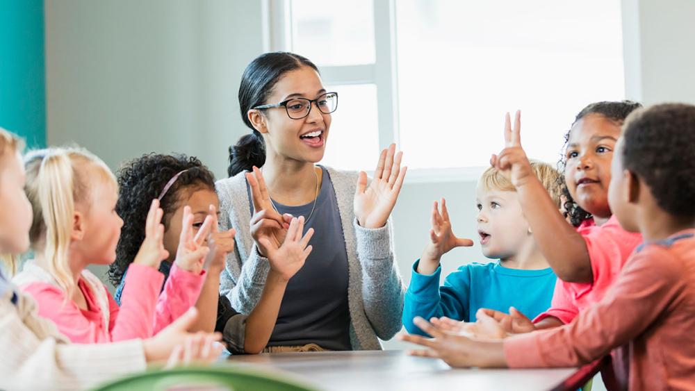 Teacher in classroom with kindergarten class