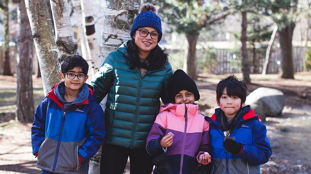 Colleen Elep standing with students outside in the winter