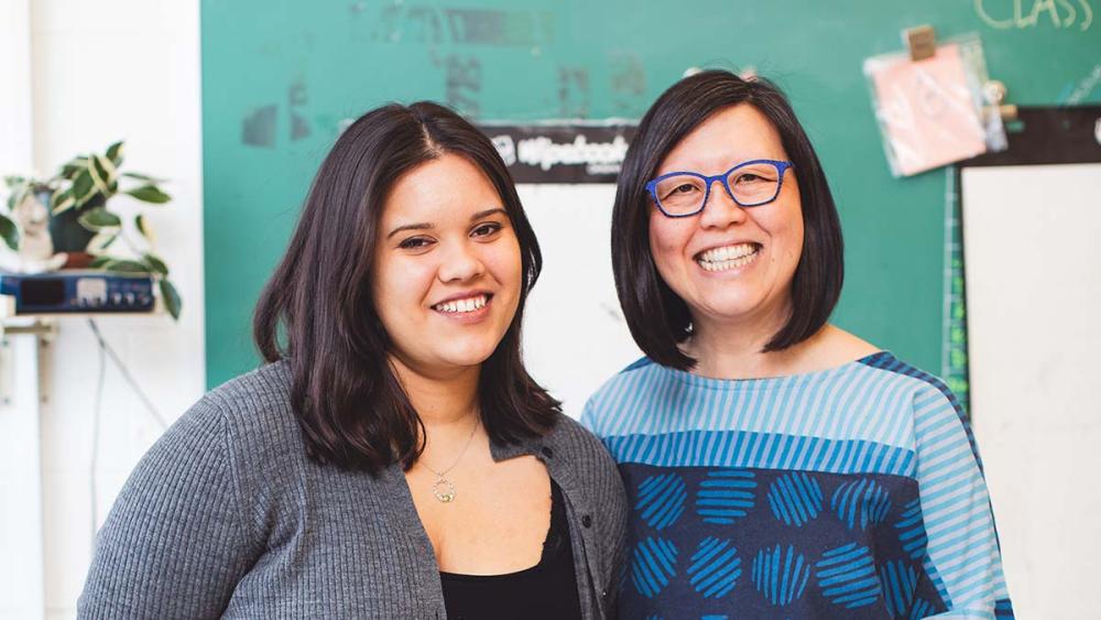 Climate Justice Activist Cecilia La Rose-Luciuk posing with Emily Chan in a classroom