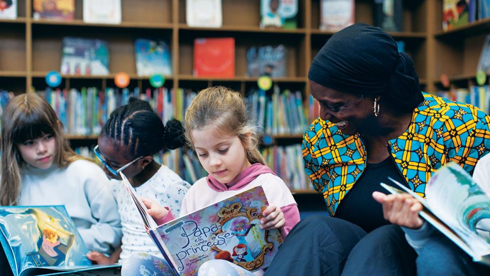 Gloria Ladson-Billings reading books with children in library