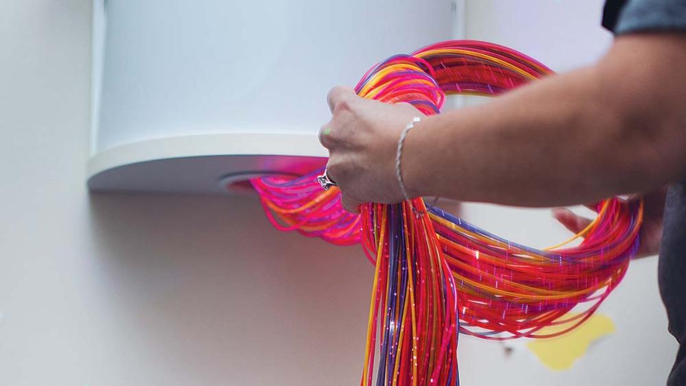 Wall mounted container full of cables