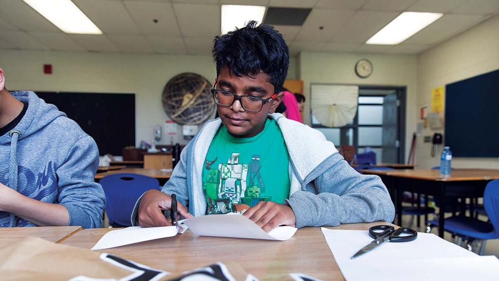 Students working on care cupboard sign