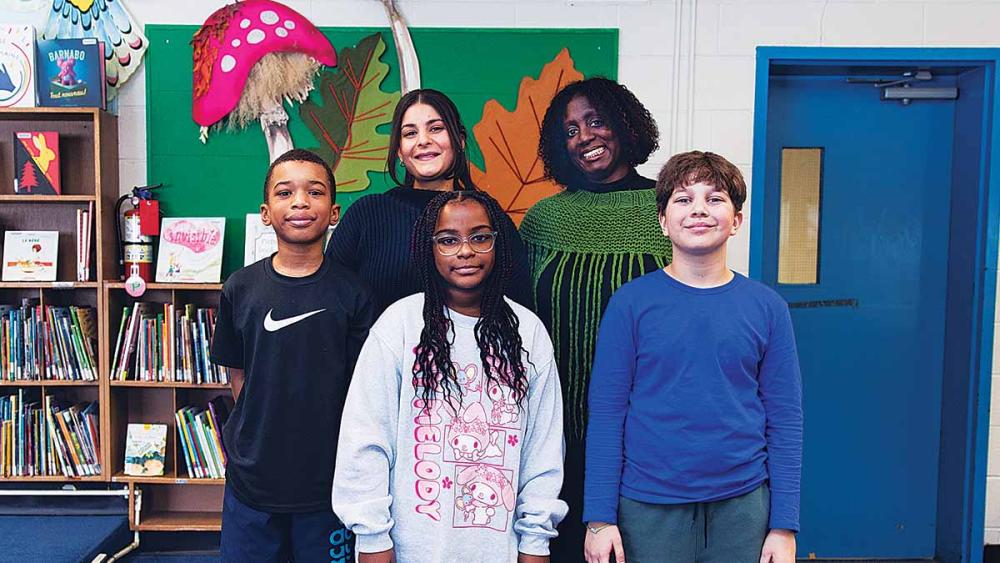 Karen Devonish-Mazzota And Leanna Bornstein posing with students in the library