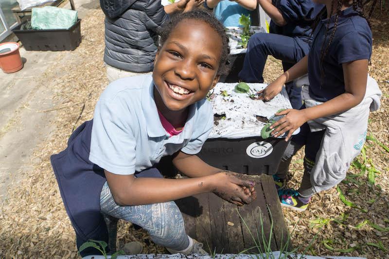 Student working in garden. Photo courtesy of Generation Nutrition