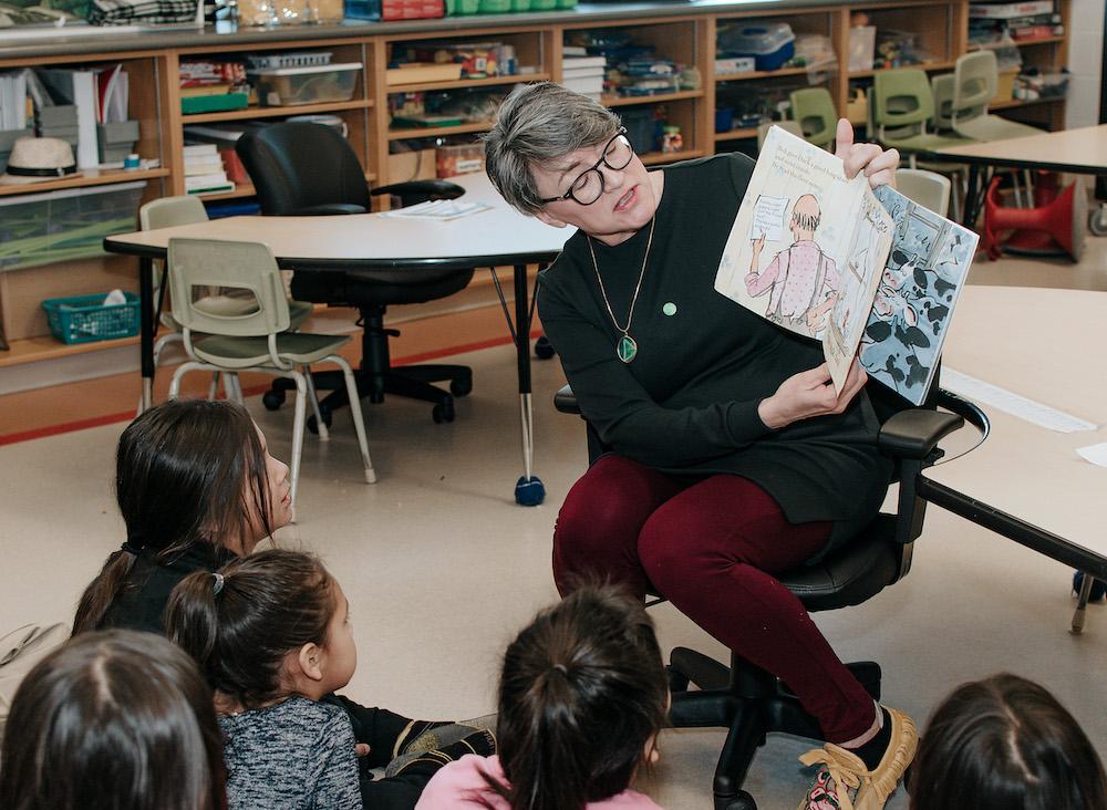 teacher reading book to classroom