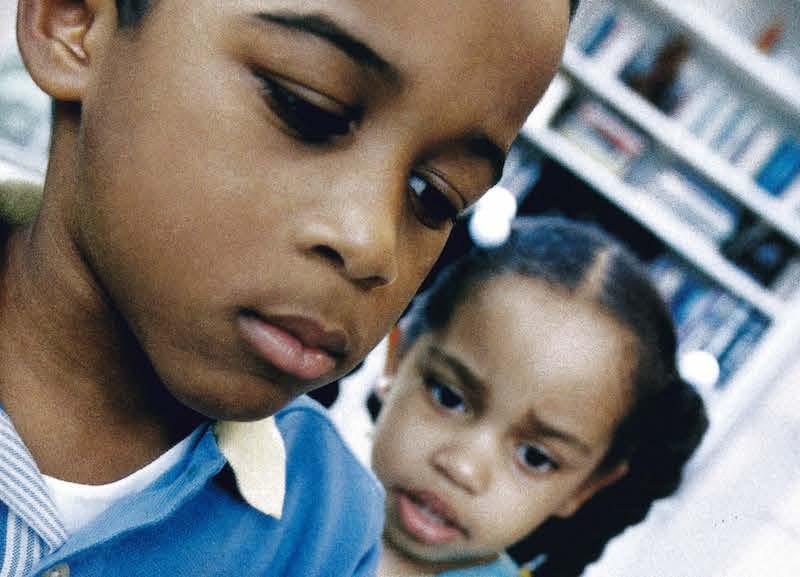 children in classroom looking at globe of world