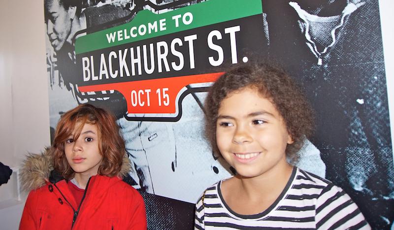 Kids standing in front of Blackhurst street sign