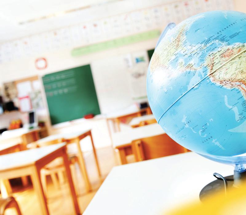 World globe sitting on desk in classroom