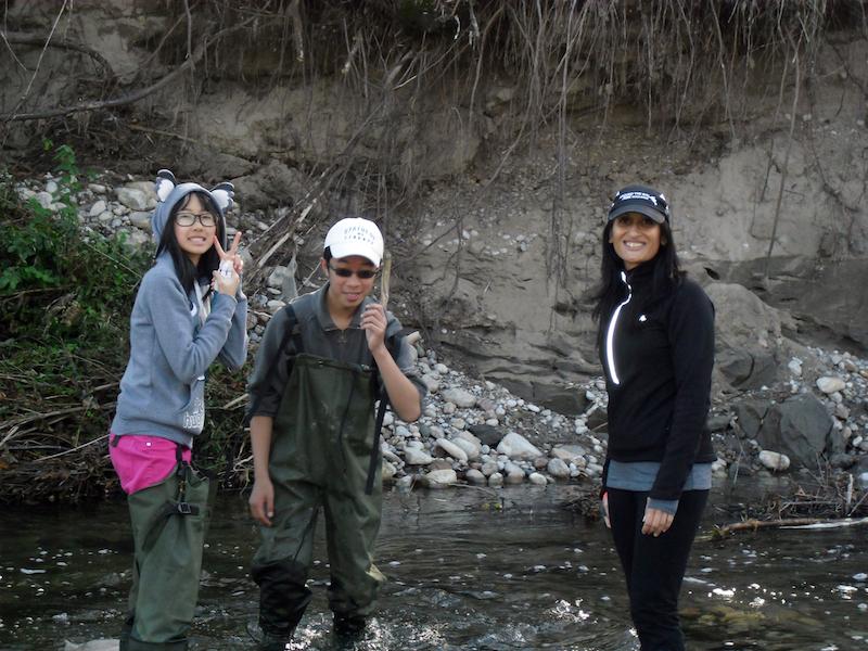 Farah Wadia and students standing in river.