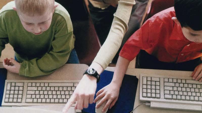 children using computers in classroom