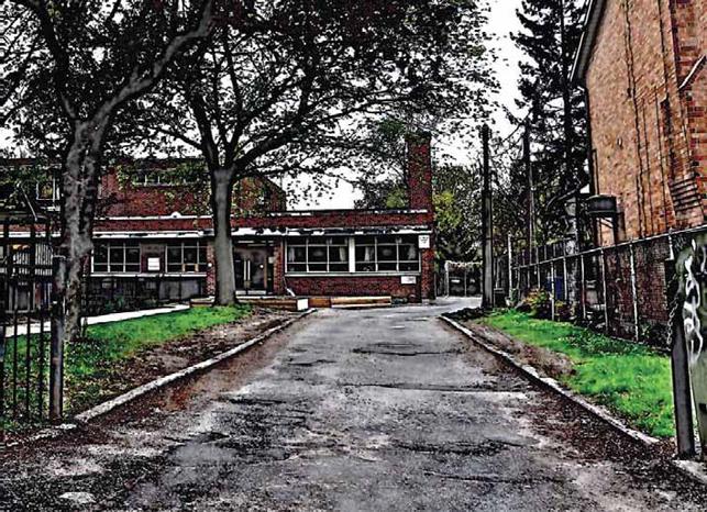 Photo of school with road in foreground and heavy HDR post-editing