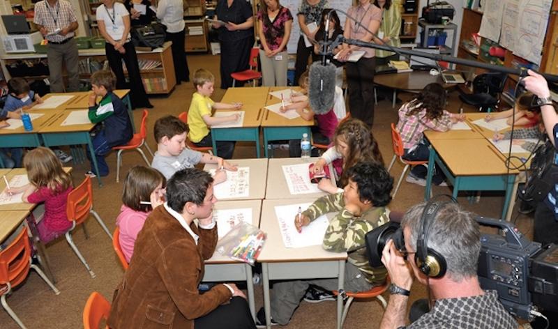 media filming teacher and students in classroom