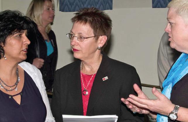 three women standing together having discussion