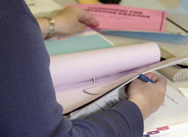 closeup of teacher flipping through book