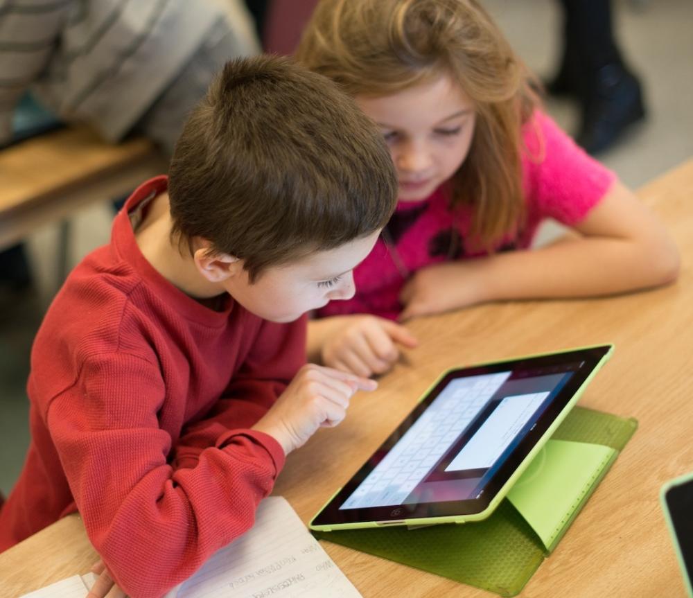 Two young students working with tablet