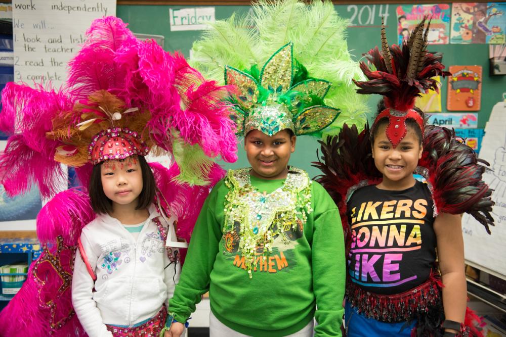 Young elementary students wearing Caribana style headwear