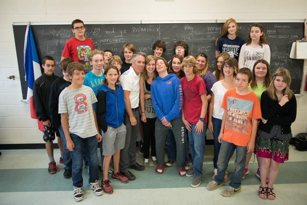 Group of elementary students standing together at front of classroom