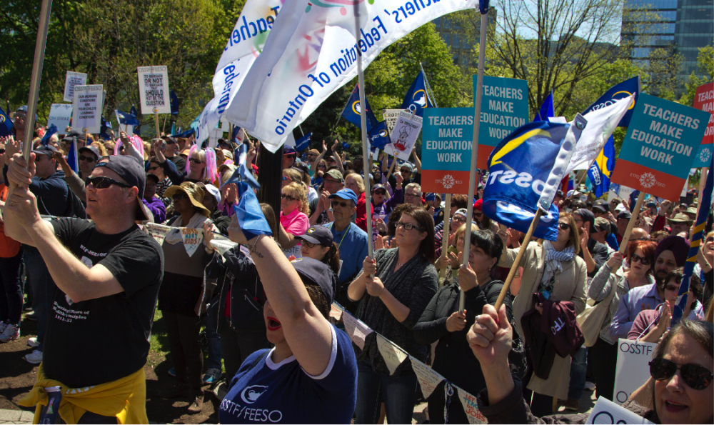 ETFO members standing with signs at rally