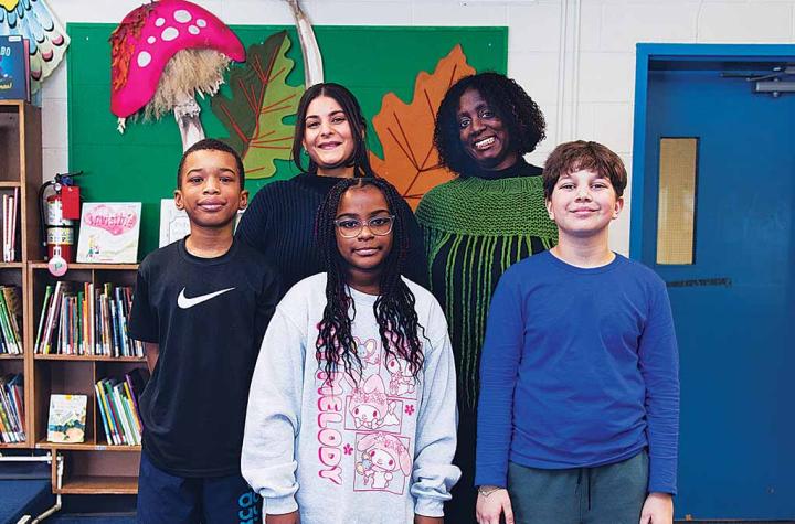 Karen Devonish-Mazzota And Leanna Bornstein posing with students in the library
