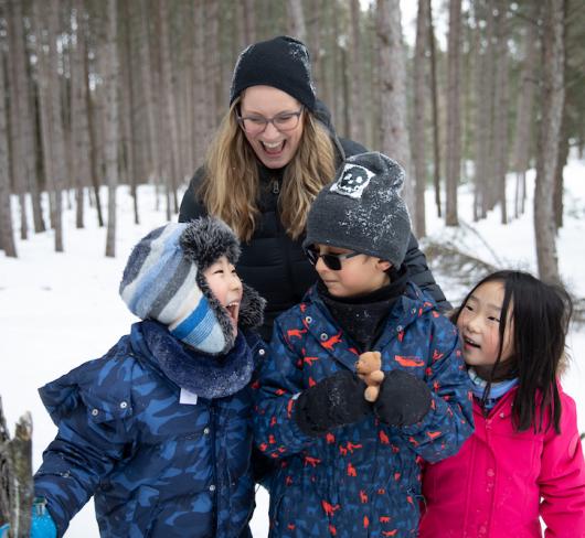 teacher with students outside in snow