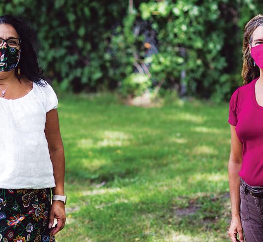 Jennifer Baron and Towana Brooks standing outside wearing masks while social distancing