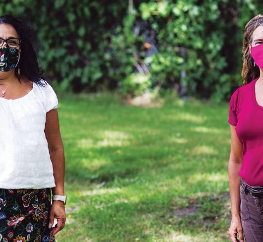 Jennifer Baron and Towana Brooks standing outside wearing masks while social distancing