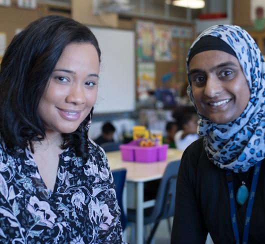 Two people sitting together in classroom