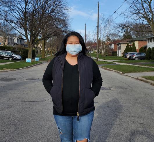 Woman standing in street wearing face mask