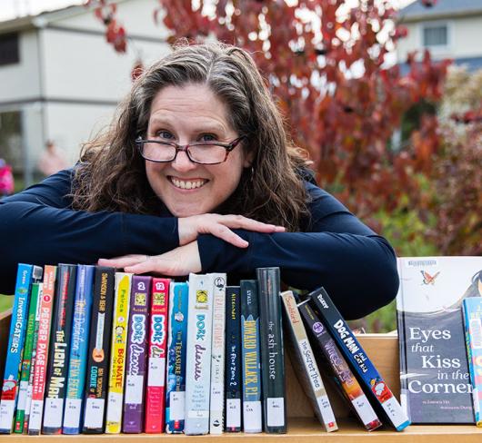 Diana Maliszewski posing outside with books