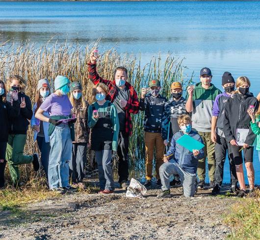 Classroom standing in front of lake