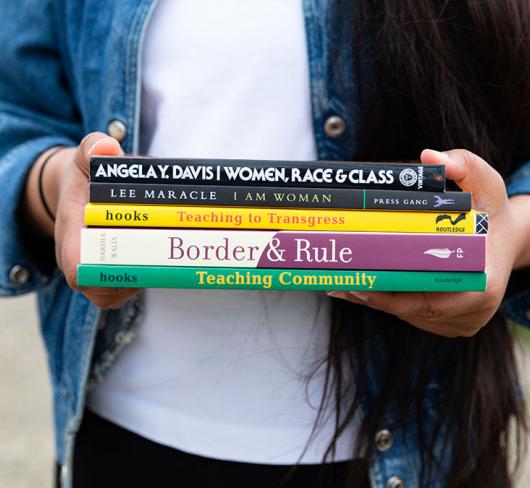 Neeru holding books related to feminism