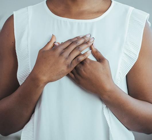 Woman holding hands to chest