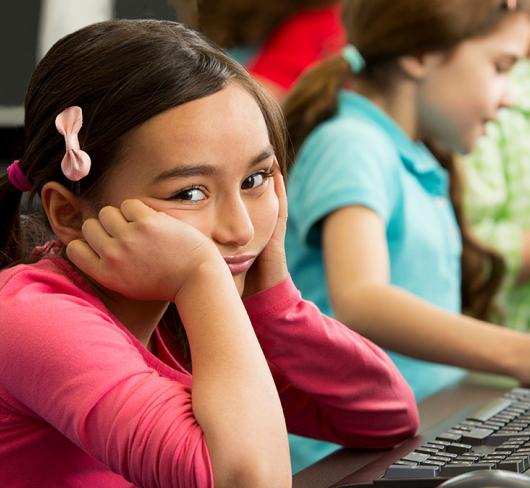 Young girl looking frustrated in classroom