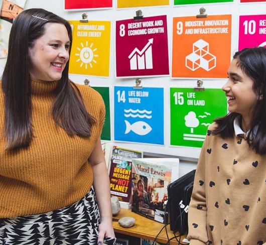 Sarah Lowes and Gweneth Arumainayaga talking in a classroom