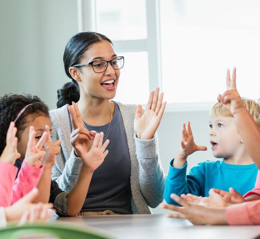 Teacher in classroom with kindergarten class