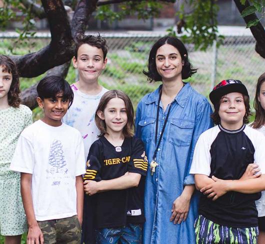 Gradeschoolers standing outside with their teacher