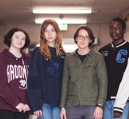 Diverse group of students standing in hallway of school