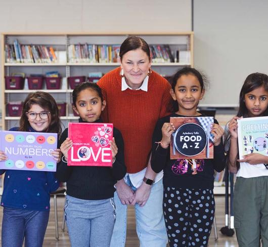 Teacher posing with her students