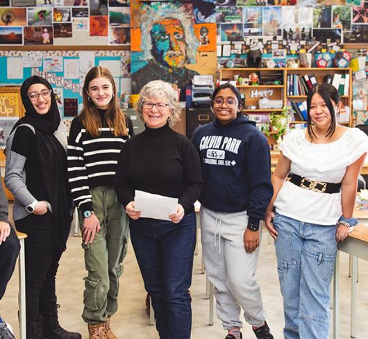 Dawn Williams posing with students in classroom