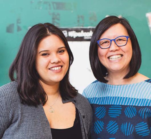 Climate Justice Activist Cecilia La Rose-Luciuk posing with Emily Chan in a classroom