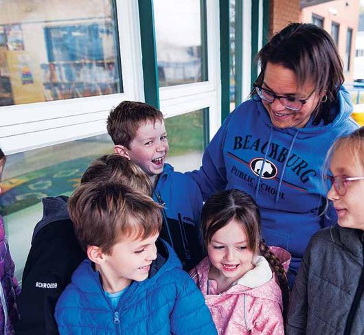Nancy Campbell and her class standing outside of school