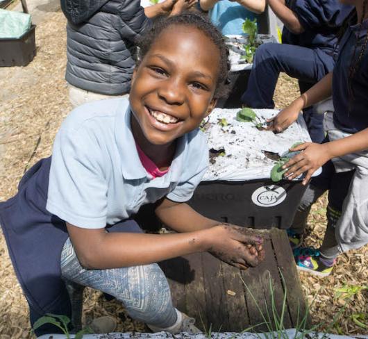 Student working in garden. Photo courtesy of Generation Nutrition