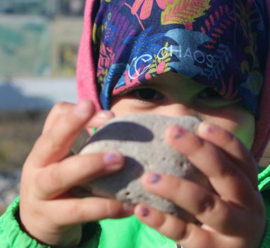 Child holding rock. Photo courtesy Tanya Leary